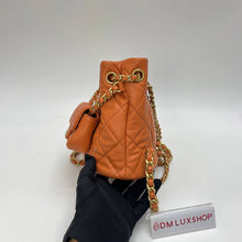 Load image into Gallery viewer, Chanel 23A Orange Bucket Backpack
